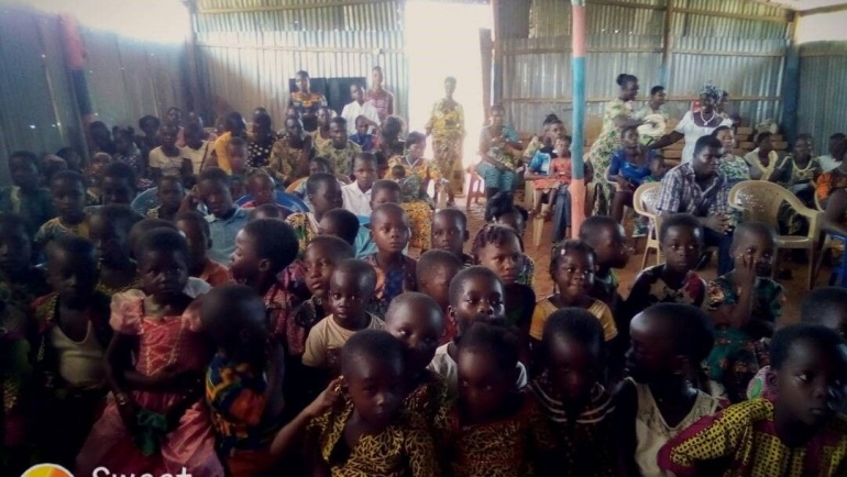 The children waited to receive the first donation from the staff